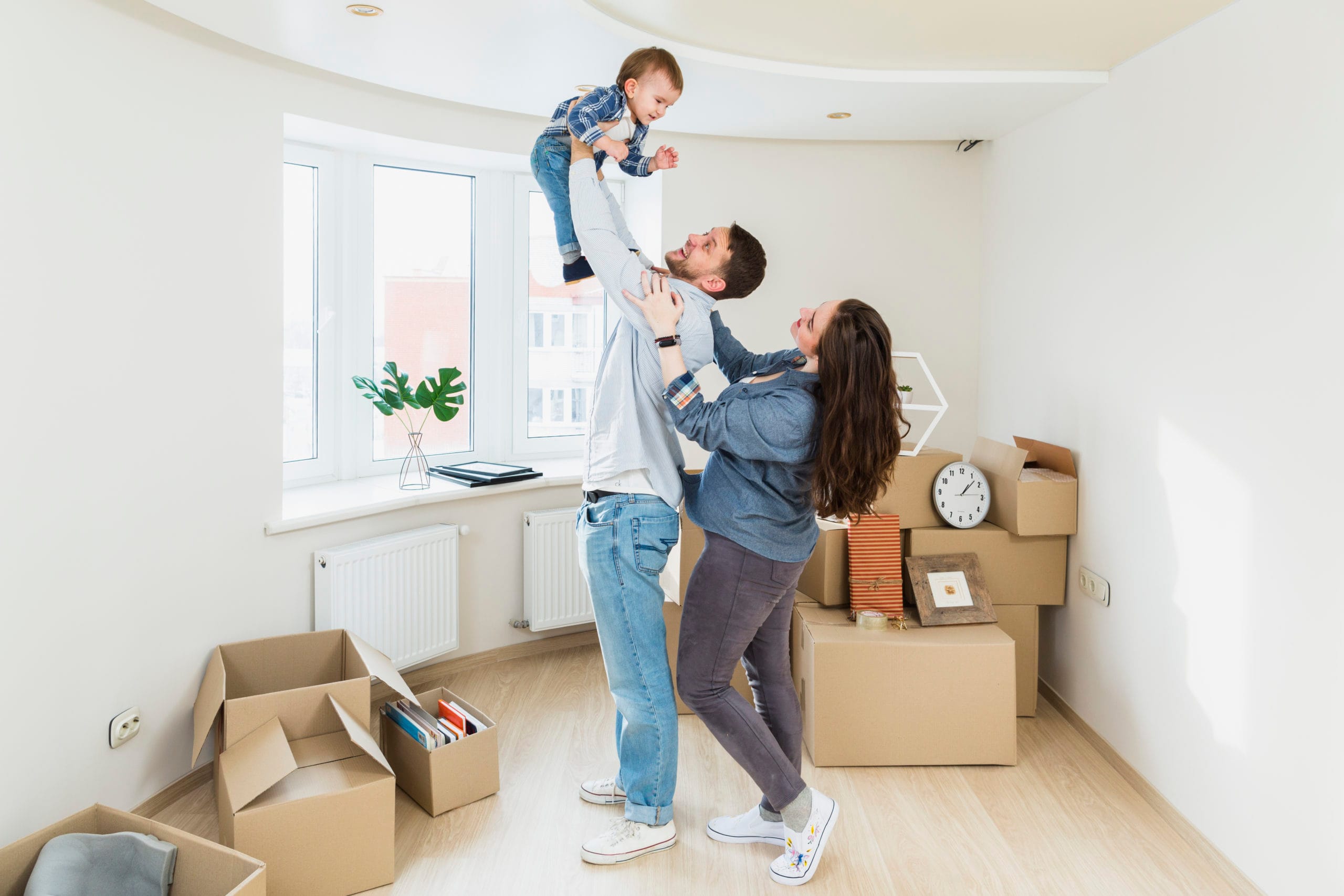 Parents lifting their baby