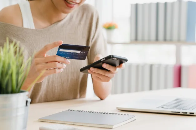 Tenant is holding a cellphone and a credit card