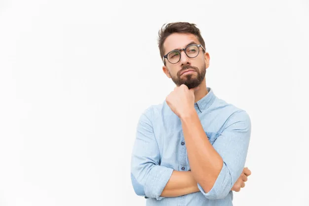A man is holding his chin and looking off to the side in thought