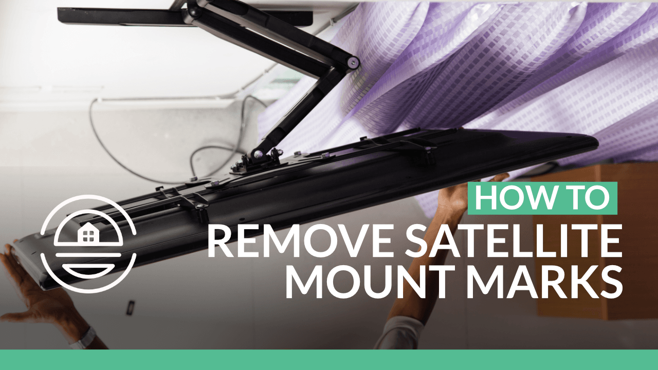 A person is removing a satellite TV mount from a wall