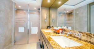 Elevating Your Bathroom Through Granite Countertops and Glass Upgrades