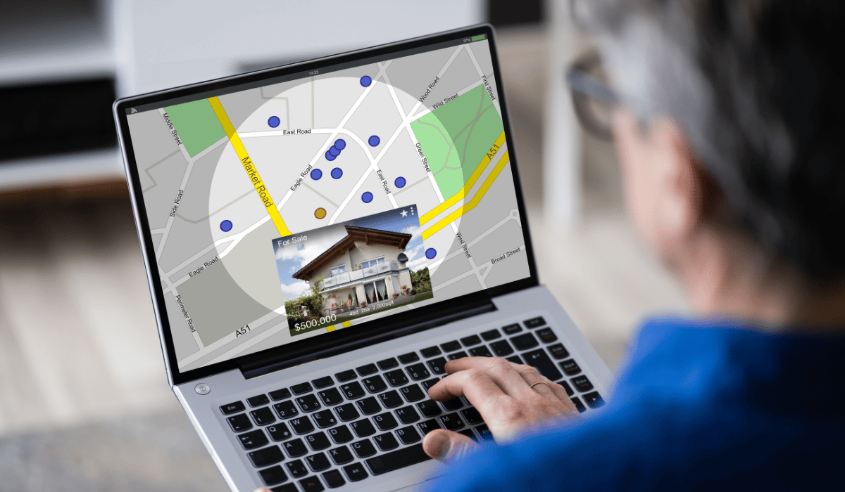A person is using a laptop to search for a house