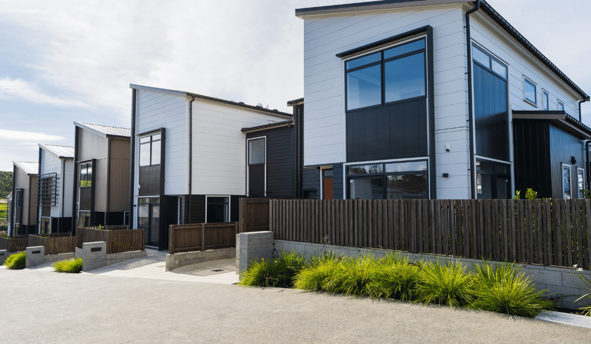 A modern two-story townhouses with white exteriors and black framed windows