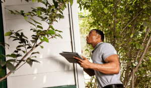 Home inspector with tablet inspects a house.