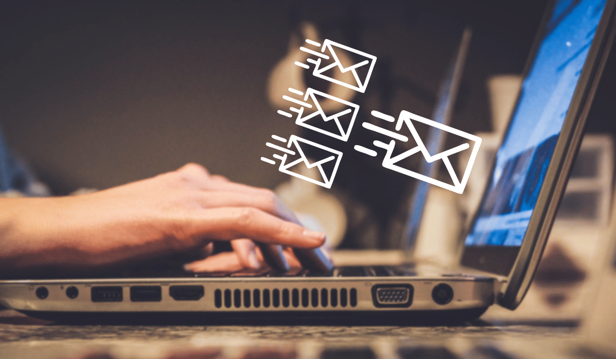 Person typing on a laptop with animated email icons, illustrating communication for canceling maintenance requests in property management.