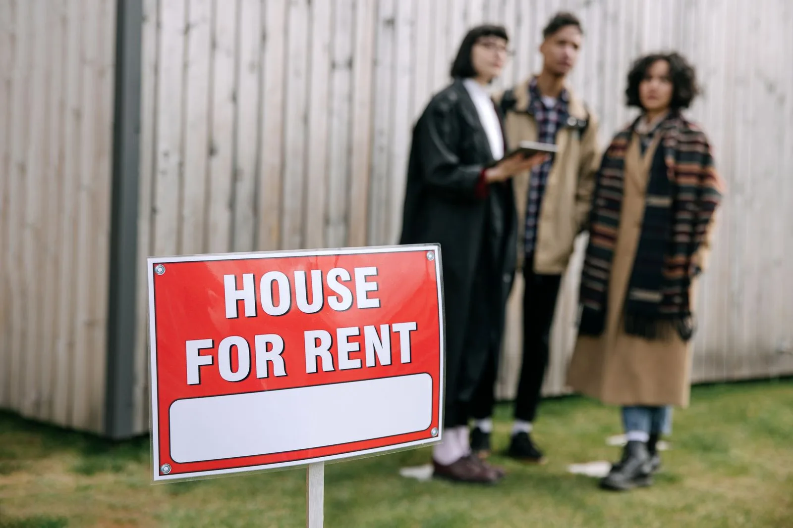 Diverse group of renters viewing a house for rent sign, representing today's varied tenant demographics