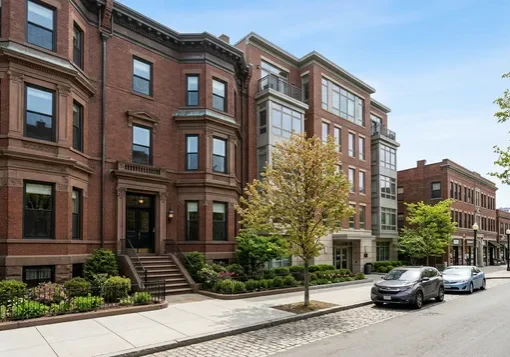 Historic brownstone next to a mid-rise condominium building in Brookline, MA
