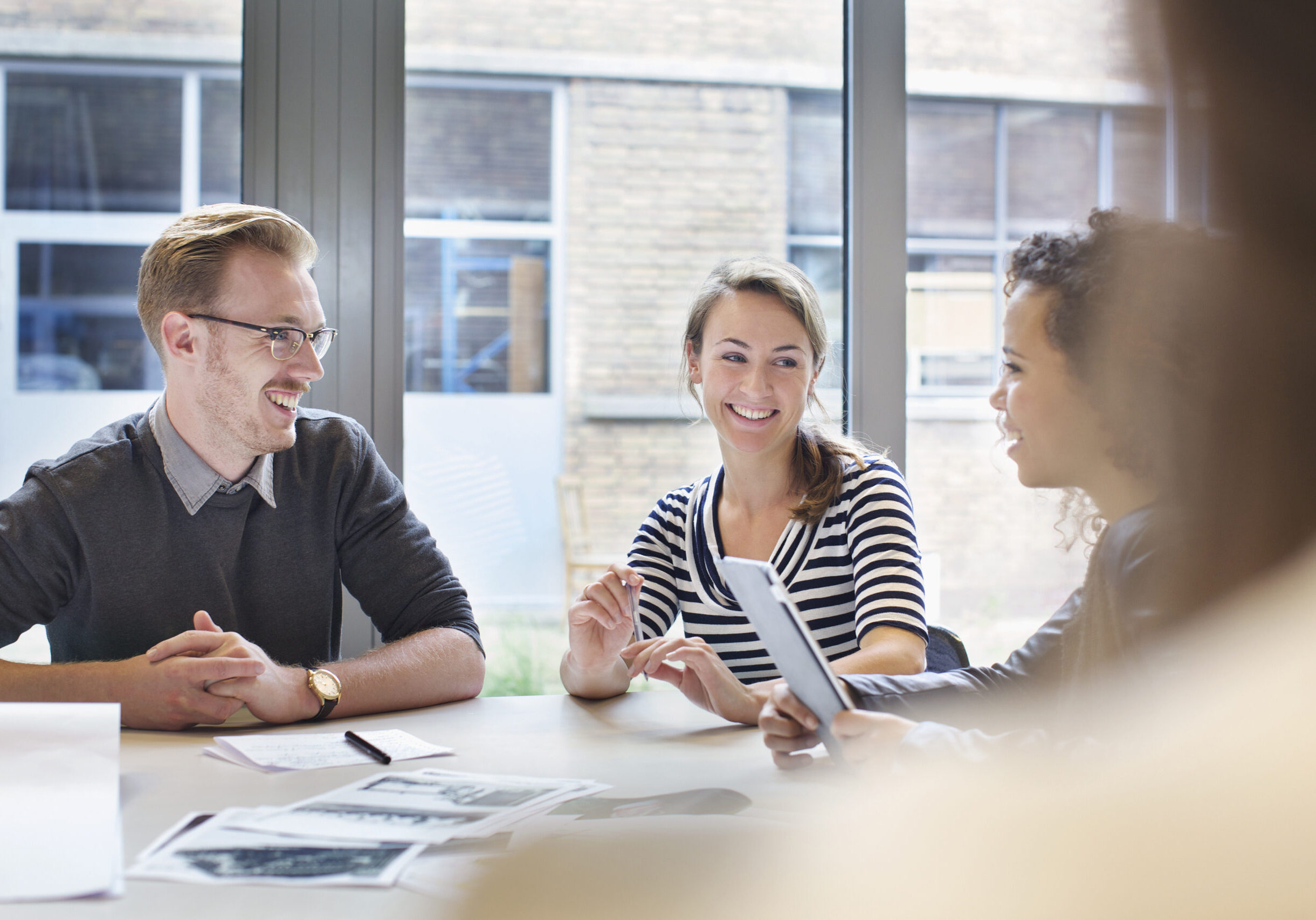 Design team meeting at conference table in creative office
